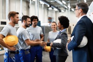 handshake between businesswoman and construction worker